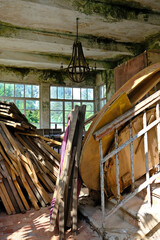 Abandoned building interior with lots of wooden boards and a large window