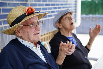 Active old age making jokes wearing hats