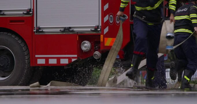 A special team of firefighters seizes hoses from a firetruck and embarks on a perilous mission to extinguish a blazing fire, showcasing their bravery and professional expertise in tackling a hazardous