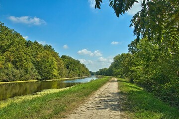 Sunny Summer landscape of a recreational trail beside the remains of a lock on the Hennepin Canal in Northern Illinois.