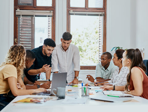 People, startup and meeting with computer, documents and review for project management in office. Group, men and women with laptop, paperwork and graphic design team with planning at creative agency