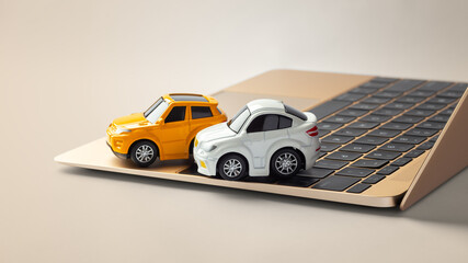 Online car business concept, car toy on laptop on gold background