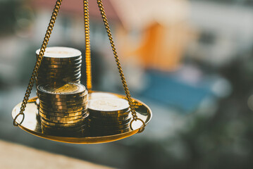 Coins stack with balance scale. Money management, financial plan, time value of money, business...