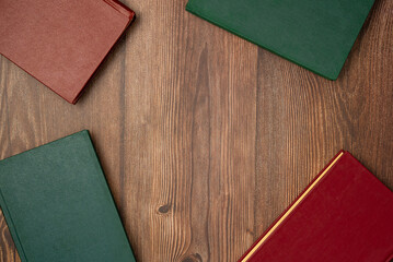 Books on wooden background from above. Flat lay, top view. Copy space