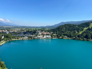Fototapeta premium Panoramic view of Bled settlement and on Lake Bled (Blejsko jezero, Bleder See oder Veldeser See) from the castle of Bled (Blejski grad) - Bled, Slovenia