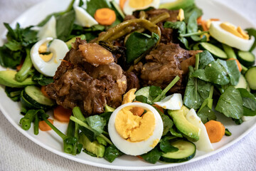 Beef oxtail cooked with watercress and served with salad. Hearty and nutritious low carb food