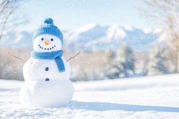 Obraz premium Snowman wearing blue hat and scarf, standing in a snowy field with snow-covered mountains in the background.