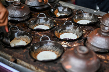 Photo of a typical serabi cake from Solo, Central Java being baked