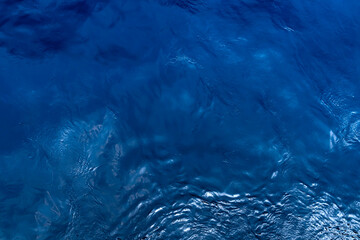Top view of blue sea water. Blue water background.