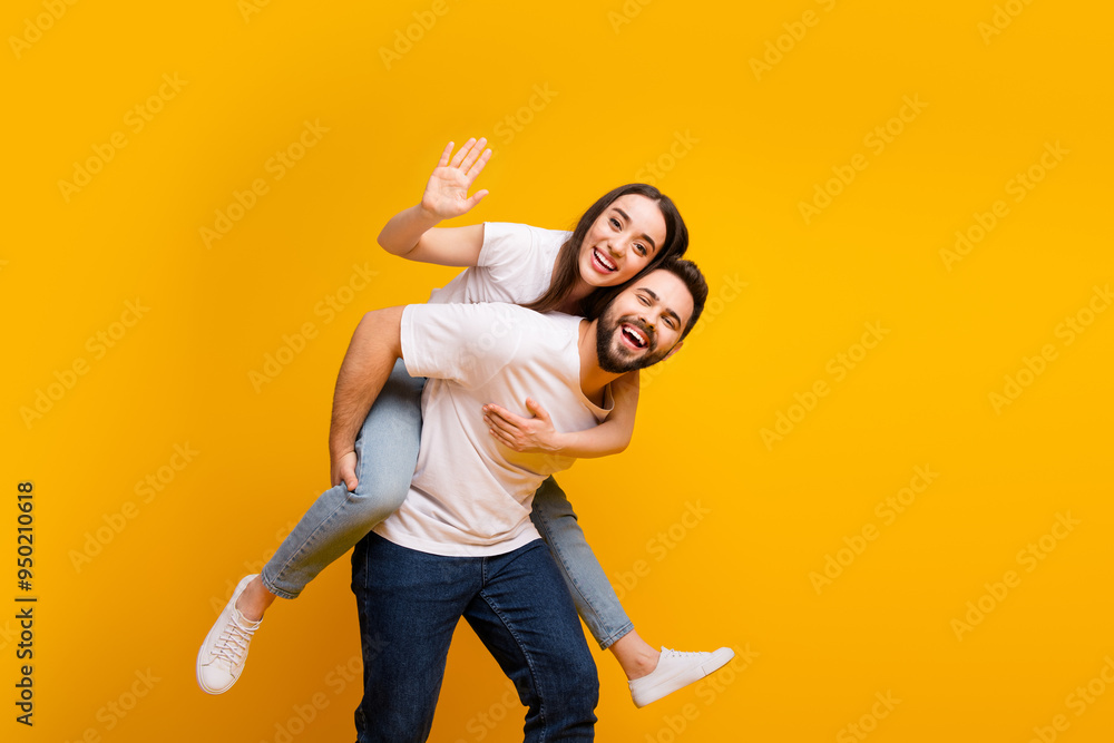 Poster Photo portrait of attractive young man woman piggyback carry wave hand hi dressed stylish white clothes isolated on yellow color background