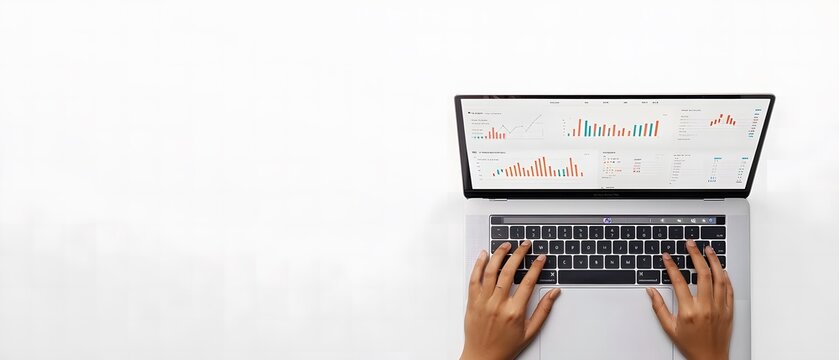 Photo of a person typing on a laptop with graphs and charts displayed in a top view against a white background,workspace
