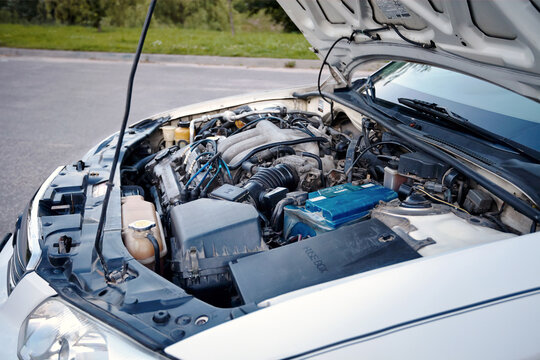Berlin, Germany - JULY, 2 2013: Pearl white Mazda Millenia or Mazda Xedos 9 detailing engine bay with V6 DOHC engine with opened engine hood.