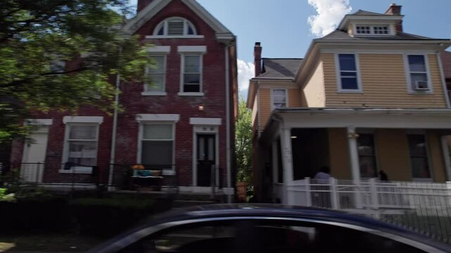 City and townhouses housing and residential homes on outskirts of downtown center of Columbus, Ohio in the midwest part of the United States in a low income and middle class suburb and neighborhood