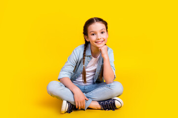 Photo of cheerful glad adorable pretty girl wear stylish denim clothes isolated on yellow color...
