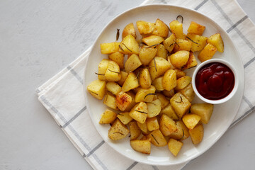 Homemade Oven Roasted Potatoes with Ketchup on a Plate, top view. Copy space.