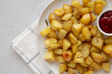 Homemade Oven Roasted Potatoes with Ketchup on a Plate, top view. Copy space.