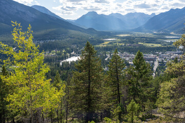 Overlooking the Town of Banff from Tunnel Mountain Trail summit in summer sunny day. Banff National Park, Canadian Rockies, Alberta, Canada.