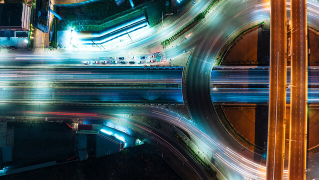 Expressway top view, Road traffic an important infrastructure, car traffic transportation above intersection road in city night, aerial view cityscape of advanced innovation, financial technology	