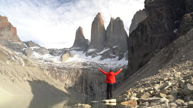Hiker at Base Las Torres mountain with lake in Torres del Paine National Park, Patagonia, Chile