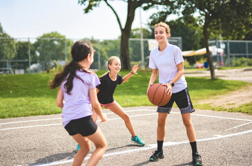 Childs girls Team in sportswear playing basketball game