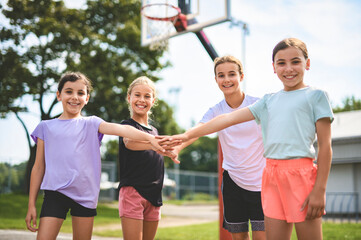 Childs girls Team in sportswear playing basketball game