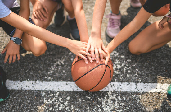 hand over hand view with basketball on a basket court