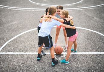 Childs girls Team in sportswear playing basketball game