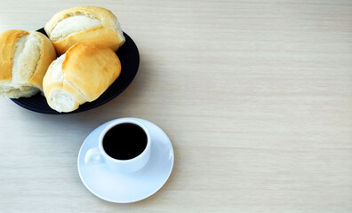  Some French Bread Dinner Rolls on the table and cup of coffee with large copy space. 

