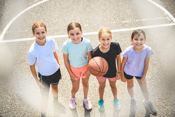 Fototapeta premium Childs girls Team in sportswear playing basketball game