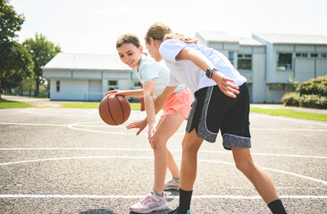 Fototapeta premium two childs girls in sportswear playing basketball game