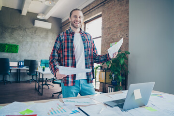 Portrait of young office worker man desk documents wear shirt loft interior business center indoors