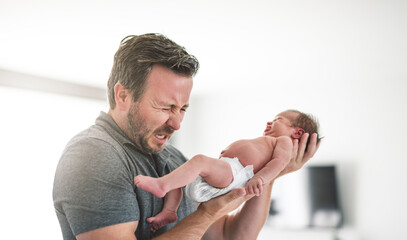 Father change diaper to baby girl on a baby changing table