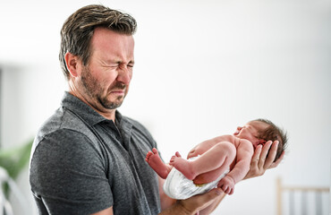 Father change diaper to baby girl on a baby changing table