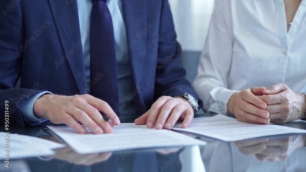 Wall mural business people wearing suits signing important documents during a corporate meeting. win-win concep