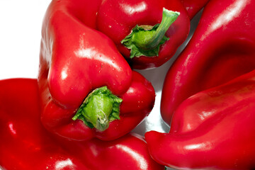 red bell peppers on white close up
