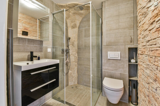 Modern bathroom with stone wall and glass shower