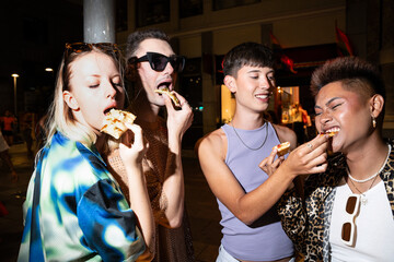 Diverse friends sharing pizza on LGBTQIA+ night out