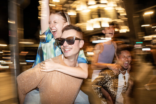 Joyful LGBTQIA+ friends enjoying a night out together