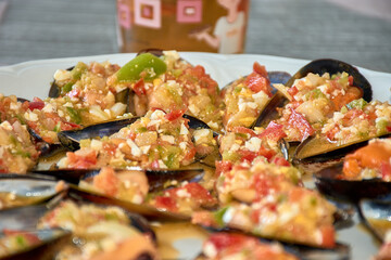 Deliciously prepared mussels with colorful vinaigrette topping