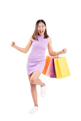 Excited young woman in a purple dress celebrates with colorful shopping bags. This image is perfect for themes related to shopping, retail, and consumer happiness