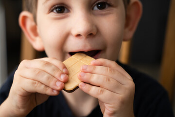 Kid eats food. Focus on the food and face on background