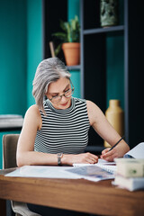 Business, mature woman and writing with paperwork, busy and project management in office as...