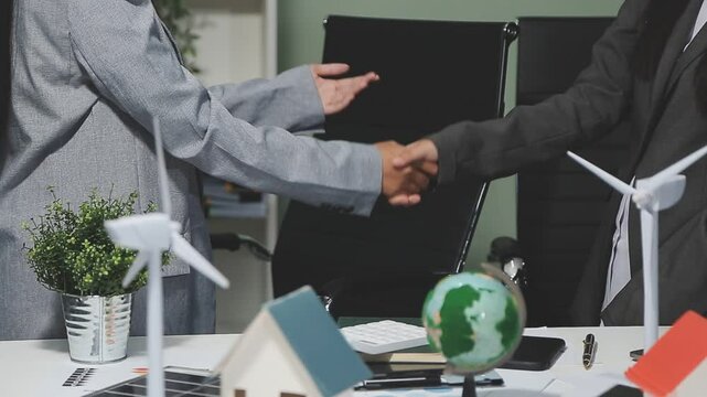 Diverse group of business people discussing for alternative energy utilization for greener sustainable Earth by reducing CO2 emission and carbon credit with renewable clean energy technology. Quaint