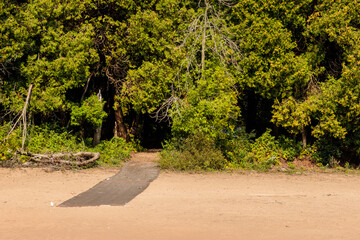 A small mat extends from the shoreline trail out over the beach to make the beach more accessible to everyone at Harrington Beach State Park, Belgium, Wisconsin