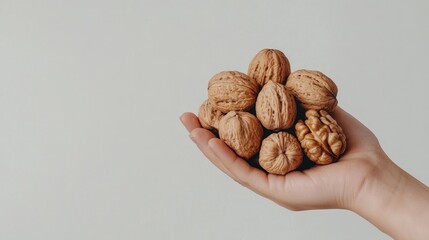 Hand holding a bunch of fresh walnuts, natural brain food, rich in omega-3 fatty acids