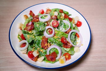 Healthy vegetable salad of fresh tomato, onion, lettuce  on plate. Diet menu. Top view.