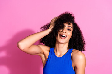 Photo portrait of attractive young woman touch hair hairdo dressed stylish blue clothes isolated on pink color background