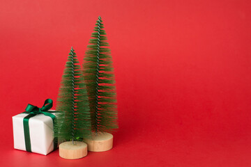 Small christmas trees with decoration on color background