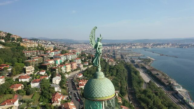 Amazing aerial view of Victory Lighthouse in Trieste, Italy, during the afternoon. The iconic Faro della Vittoria with a breathtaking view of the entire city and Adriatic Sea.
