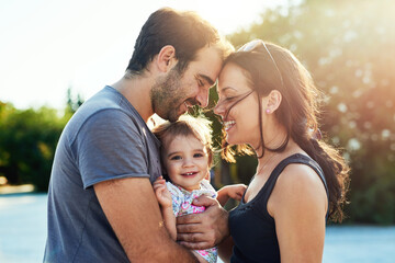 Happy, love and parents with baby in park for bonding, loving relationship and relax together...